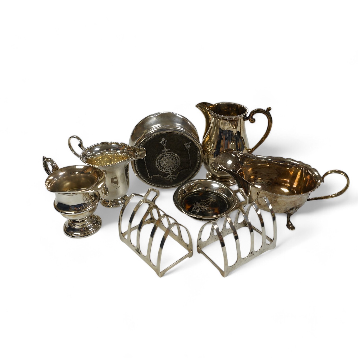 Sundry small silver including a pair of toast racks, Sheffield, 1936, three cream jugs, a sauceboat and two tortoiseshell mounted items. Condition - poor to fair to good